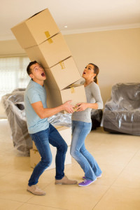 45857577 - screaming young couple with falling stack of boxes
