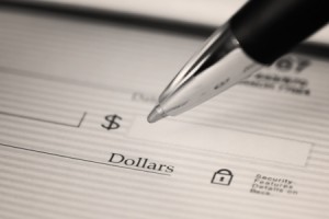 13355080 - close up of pen filling in a blank check