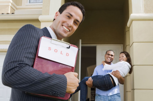 35787848 - hispanic real estate agent and african couple in front of house
